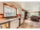 Bright kitchen featuring white cabinets, stainless steel appliances, and a view to the Gathering room at 12927 W Shadow Hills Dr, Sun City West, AZ 85375