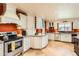Spacious gourmet kitchen with stainless steel appliances, custom cabinetry, and a center island, perfect for cooking and entertaining at 12927 W Shadow Hills Dr, Sun City West, AZ 85375