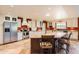 Large kitchen with stainless appliances, custom cabinetry, and a central island with bar seating, perfect for Gathering gatherings at 12927 W Shadow Hills Dr, Sun City West, AZ 85375