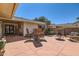 Outdoor patio with seating, lush plants, and a charming fountain, creating a perfect space for relaxation and entertaining at 12927 W Shadow Hills Dr, Sun City West, AZ 85375