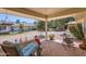 Covered patio features comfortable seating and a view of the spacious yard at 12927 W Shadow Hills Dr, Sun City West, AZ 85375