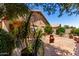 Secluded backyard includes desert landscaping, a covered patio, and lush green plants at 1325 E Linda Dr, Casa Grande, AZ 85122
