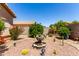 Lush backyard features a stone water feature, cacti, shrubbery, and vibrant red flowering bushes at 1325 E Linda Dr, Casa Grande, AZ 85122