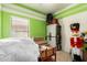 A colorful bedroom featuring a window, tile floors, and creative design elements perfect for a or guest at 1325 E Linda Dr, Casa Grande, AZ 85122