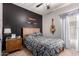 Comfortable bedroom featuring tile floors, dark accent wall, and a cozy ambiance, ideal for relaxation at 1325 E Linda Dr, Casa Grande, AZ 85122