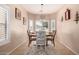 Bright dining area featuring tile floors, a round wooden table, and a stylish chandelier, perfect for Gathering meals at 1325 E Linda Dr, Casa Grande, AZ 85122