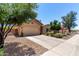 Inviting home with low-maintenance landscaping, a spacious driveway, and a neutral color palette at 1325 E Linda Dr, Casa Grande, AZ 85122