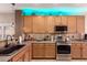 Contemporary kitchen equipped with stainless appliances, updated cabinetry, and decorative lighting at 1325 E Linda Dr, Casa Grande, AZ 85122