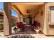 Cozy covered patio with red patio furniture, a ceiling fan, and decorative potted plants at 1325 E Linda Dr, Casa Grande, AZ 85122