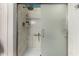 Shower featuring a frosted glass door, shelves, and marble tile at 1325 E Linda Dr, Casa Grande, AZ 85122