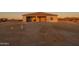 Home's backyard with covered patio awaiting landscaping in a serene desert setting at 13430 S Garnet Rd, Buckeye, AZ 85326