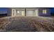 Exterior of new home showcases a covered patio and a large backyard perfect for customization at 13430 S Garnet Rd, Buckeye, AZ 85326