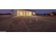 New construction home featuring a covered back patio and expansive backyard space at 13430 S Garnet Rd, Buckeye, AZ 85326