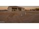 Backyard view showing the covered patio awaiting landscaping in a peaceful setting at 13430 S Garnet Rd, Buckeye, AZ 85326