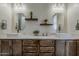 Bathroom with double sink vanity, framed mirrors, sconces, decor, and white countertop at 13430 S Garnet Rd, Buckeye, AZ 85326