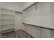 Walk-in closet with built-in shelving and racks, and wood-look flooring at 13430 S Garnet Rd, Buckeye, AZ 85326