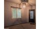 Inviting entryway with a pendant light, window and a black front door at 13430 S Garnet Rd, Buckeye, AZ 85326