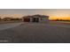 Captivating shot of the property with natural desert landscaping and a sunset backdrop at 13430 S Garnet Rd, Buckeye, AZ 85326