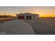 Charming home with desert landscaping, and a long driveway leading to the garage at 13430 S Garnet Rd, Buckeye, AZ 85326