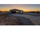 Newly constructed home featuring a long driveway and red garage door at 13430 S Garnet Rd, Buckeye, AZ 85326
