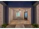 Inviting covered front porch with decorative lighting and a welcoming 'hello' doormat at 13430 S Garnet Rd, Buckeye, AZ 85326