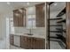 Bright kitchen with stainless steel appliances, and a walk-in pantry with custom shelving at 13430 S Garnet Rd, Buckeye, AZ 85326