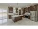 Modern kitchen featuring an island, stainless appliances, and dark wood cabinetry at 13430 S Garnet Rd, Buckeye, AZ 85326