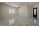 Spacious living room with high ceilings, modern ceiling fan, and stylish tile flooring at 13430 S Garnet Rd, Buckeye, AZ 85326