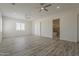 Large living room with hardwood floors and a partial view of an ensuite bathroom at 13430 S Garnet Rd, Buckeye, AZ 85326