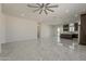 Open-concept living area with tile floors seamlessly flowing into the adjacent kitchen and dining spaces at 13430 S Garnet Rd, Buckeye, AZ 85326
