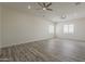 Large living room featuring hardwood floors, recessed lighting, and ceiling fans at 13430 S Garnet Rd, Buckeye, AZ 85326