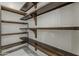 Walk in pantry with custom built-in shelving at 13430 S Garnet Rd, Buckeye, AZ 85326