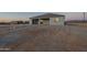 Modern home exterior featuring a covered patio, gray siding, and desert landscape at 13430 S Garnet Rd, Buckeye, AZ 85326