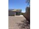 Backyard view of home with low maintenance landscaping and a covered patio area at 14038 N 162Nd Ln, Surprise, AZ 85379