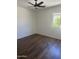 This bedroom features beautiful wood floors and a modern ceiling fan for added comfort at 14038 N 162Nd Ln, Surprise, AZ 85379