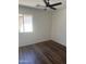 This bedroom features beautiful wood floors and a modern ceiling fan for added comfort at 14038 N 162Nd Ln, Surprise, AZ 85379