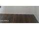 Wood-look flooring detail with white baseboards at 14038 N 162Nd Ln, Surprise, AZ 85379