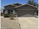 Charming single-story home with a two-car garage and low maintenance desert landscaping at 14038 N 162Nd Ln, Surprise, AZ 85379