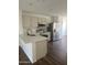 Modern kitchen features stainless steel appliances, light cabinets, quartz countertops, and wood floors at 14038 N 162Nd Ln, Surprise, AZ 85379
