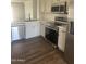 Well-appointed kitchen features stainless steel appliances, quartz countertops, and stylish hardware at 14038 N 162Nd Ln, Surprise, AZ 85379