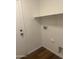 A dedicated laundry room with convenient hook-ups, shelving and door to exterior at 14038 N 162Nd Ln, Surprise, AZ 85379