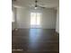Spacious living room with wood-look flooring and access to the backyard patio at 14038 N 162Nd Ln, Surprise, AZ 85379