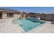Enjoy the outdoors in this backyard featuring a pool, spa, and tranquil landscaping at 15655 W Berkeley Rd, Goodyear, AZ 85395
