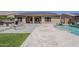 A view of the pool and patio from the yard features a fire pit and a covered patio at 15655 W Berkeley Rd, Goodyear, AZ 85395