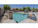 An inviting backyard with a sparkling pool, a slide, and a tranquil ambiance at 15655 W Berkeley Rd, Goodyear, AZ 85395