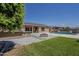 This backyard boasts a pool, spa, fire pit, and built-in barbecue, perfect for outdoor living at 15655 W Berkeley Rd, Goodyear, AZ 85395