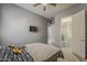 Serene bedroom featuring a walk-in closet, wall-mounted TV, and soft grey walls at 15655 W Berkeley Rd, Goodyear, AZ 85395