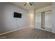 This is a bedroom offering an ample closet and neutral-colored walls and carpet at 15655 W Berkeley Rd, Goodyear, AZ 85395