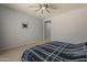 A bedroom featuring an installed TV mount on the wall and soft carpet flooring at 15655 W Berkeley Rd, Goodyear, AZ 85395