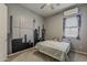Cozy bedroom with neutral tones, a city skyline mural, and a comfy bed with plush toys at 15655 W Berkeley Rd, Goodyear, AZ 85395
